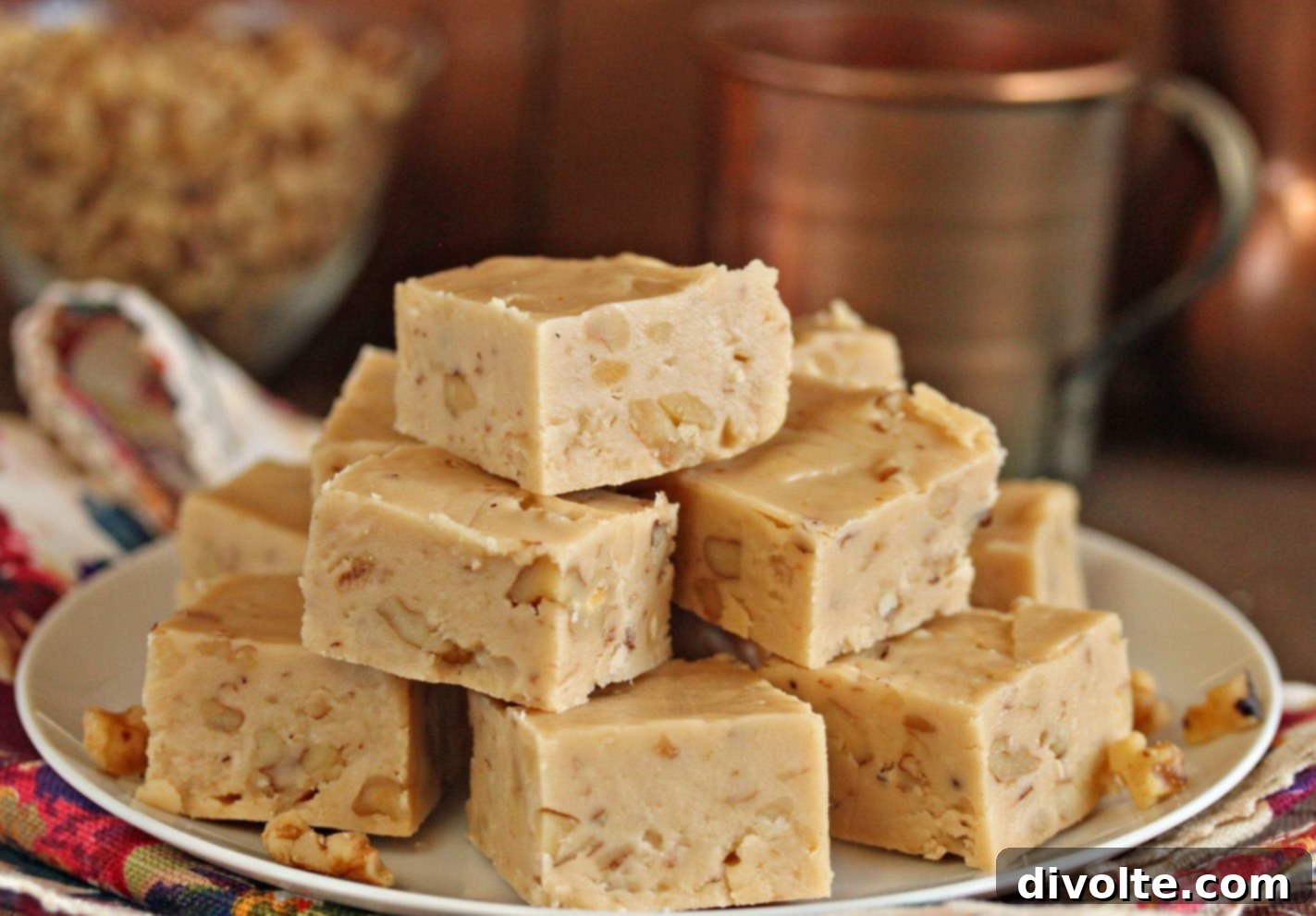 Velvety Maple Fudge Recipe 2 Delicious squares of homemade maple fudge, garnished with maple syrup