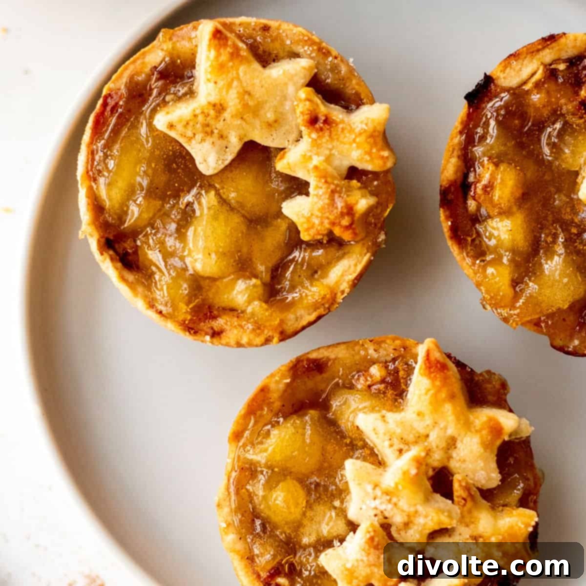Delicious golden brown mini apple pies on a cooling rack