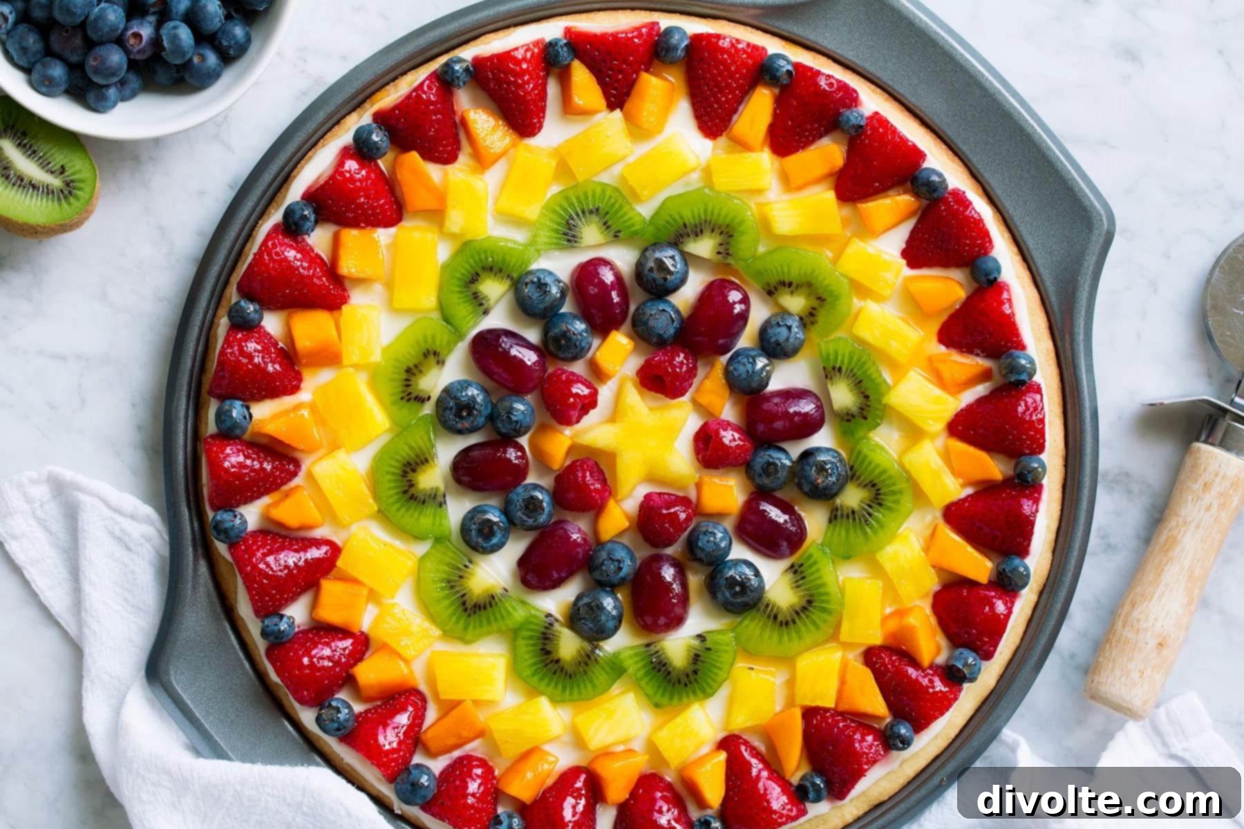 fruit-pizza-recipe - topped with fresh strawberries, kiwis, and blueberries