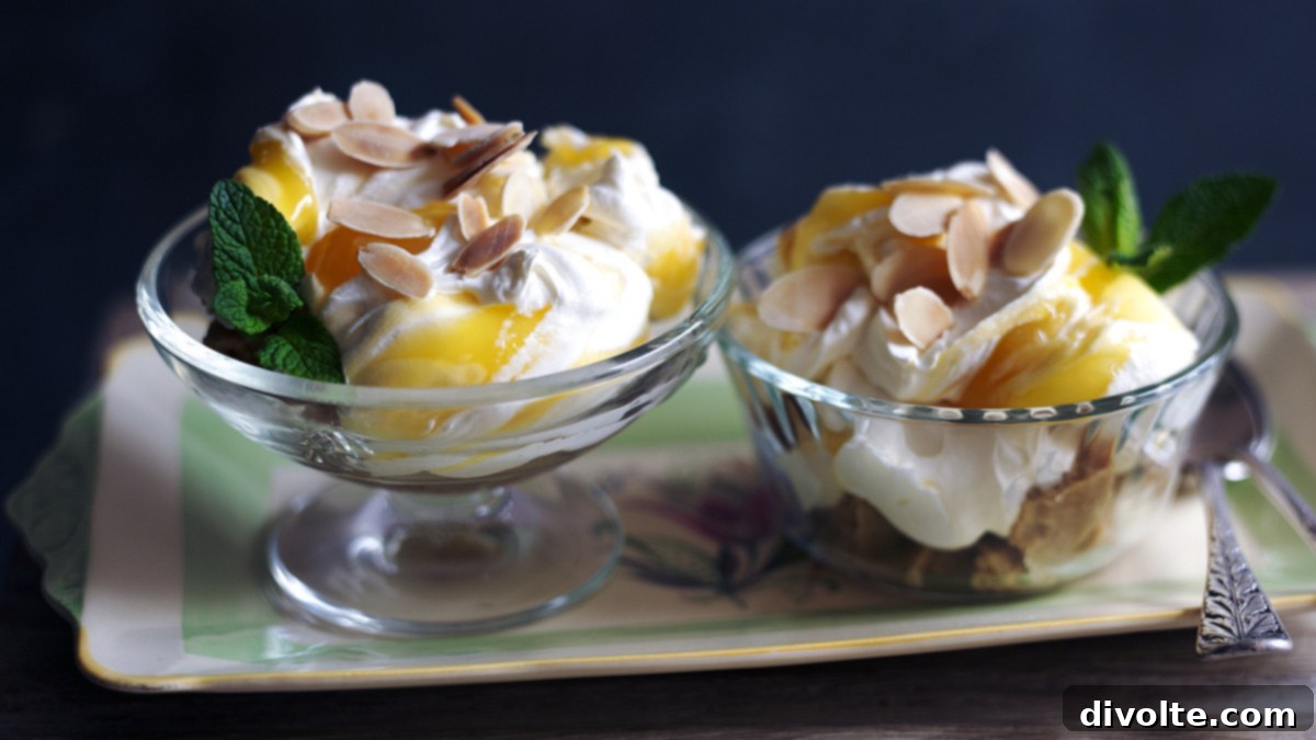 Zesty Lemon Syllabub 2 Classic Lemon Syllabub dessert in a glass with a spoon