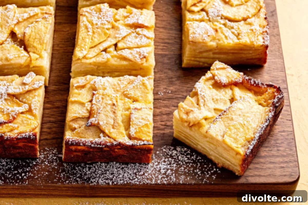 Freshly baked apple squares with a golden crust and a tender, spiced interior, ready to be enjoyed.