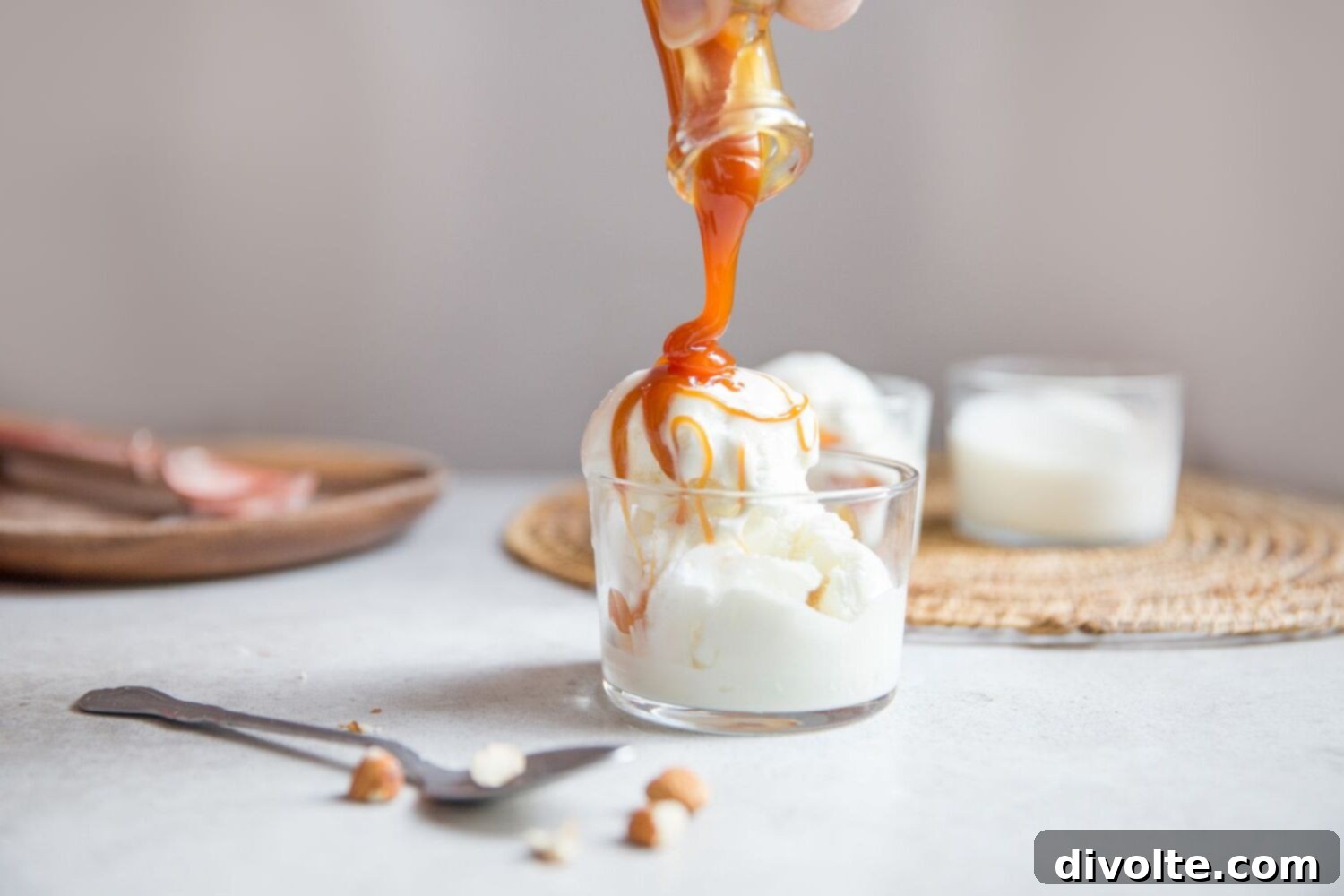 Rich, golden homemade caramel sauce drizzled over a dessert, showcasing its smooth texture and inviting color.