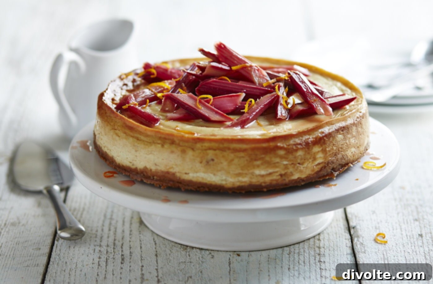 rhubarb-cheesecake-recipe - a slice of cheesecake with red rhubarb topping