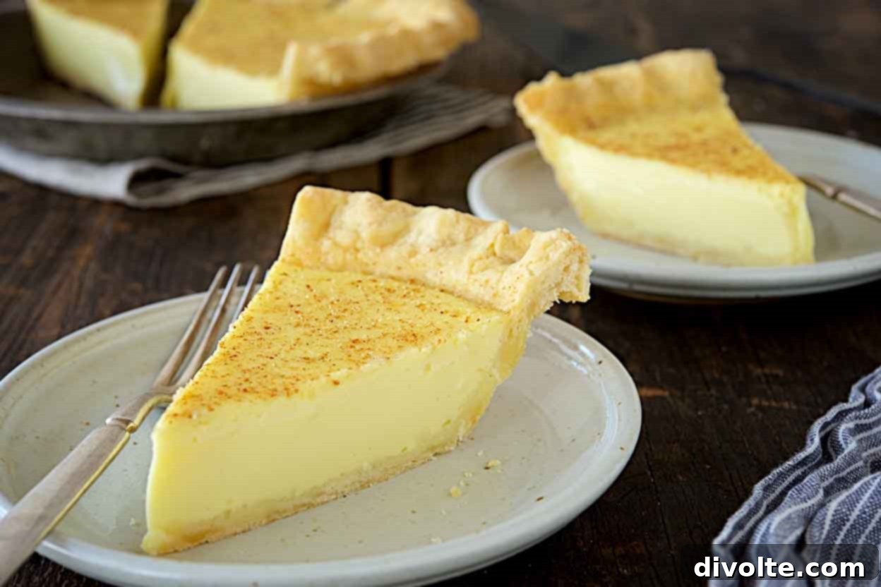 custard-pie-recipe: a slice of creamy custard pie on a plate, with a golden-brown crust and a dusting of nutmeg