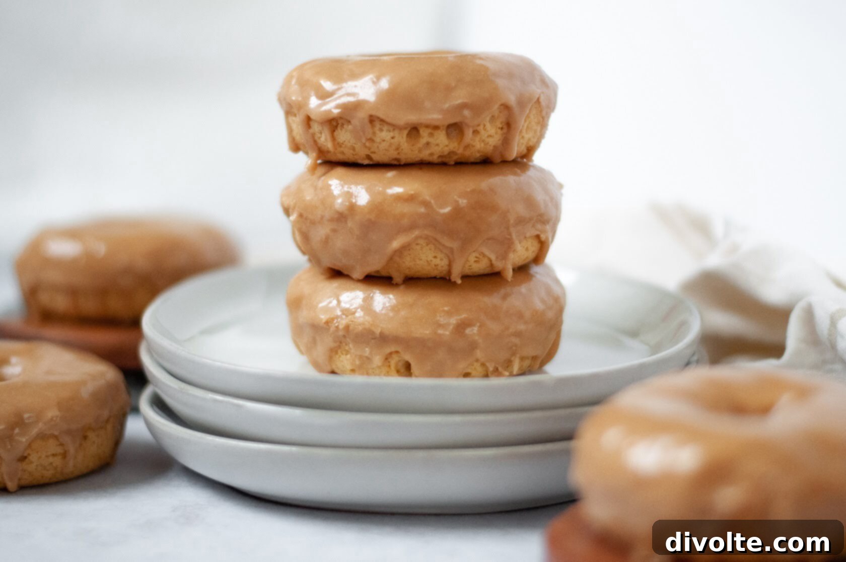 Delicious homemade maple donuts with a glossy glaze, perfect for a sweet breakfast or dessert.
