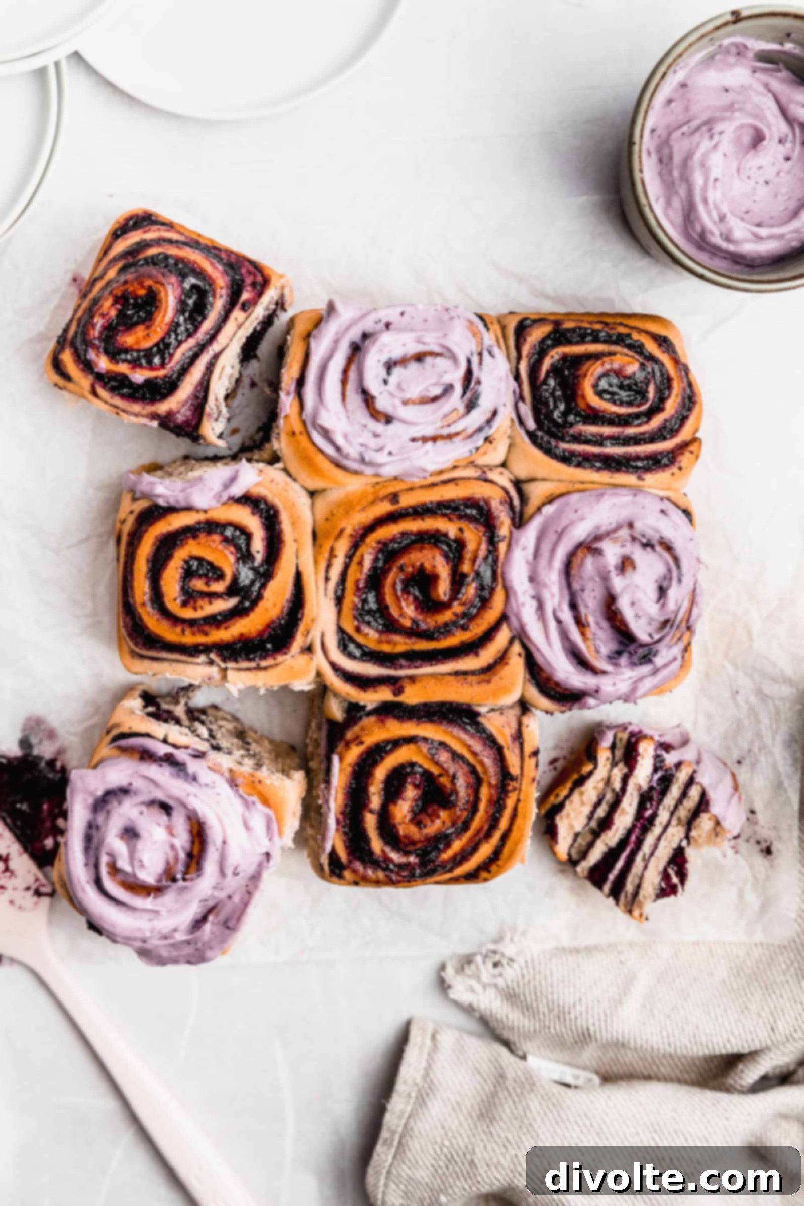 blueberry-rolls-recipe - A close-up of freshly baked, golden-brown blueberry rolls with a vibrant blueberry filling and a light glaze.